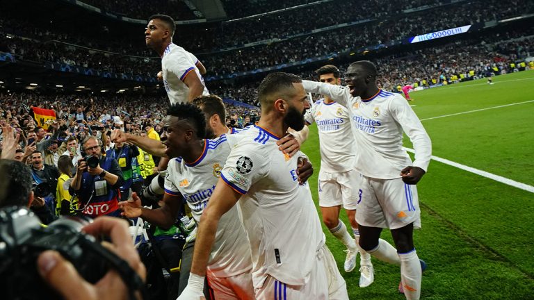 Real Madrid's Karim Benzema, center, celebrates after scoring his side's third goal during the Champions League semi final, second leg soccer match between Real Madrid and Manchester City at the Santiago Bernabeu stadium. (Manu Fernandez/AP)