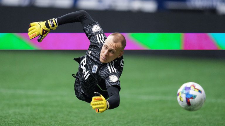 Vancouver Whitecaps goalkeeper Cody Cropper dives for a San Jose Earthquakes shot that went wide of the goal during the first half of an MLS soccer game in Vancouver, on Saturday, May 14, 2022. (Darryl Dyck/CP)