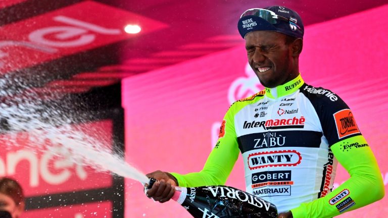 Eritrea's Biniam Girmay celebrates on the podium after winning the 10th stage of the Giro D'Italia cycling race from Pescara to Jesi, Italy, Tuesday, May 17, 2022. (Massimo Paolone/AP)