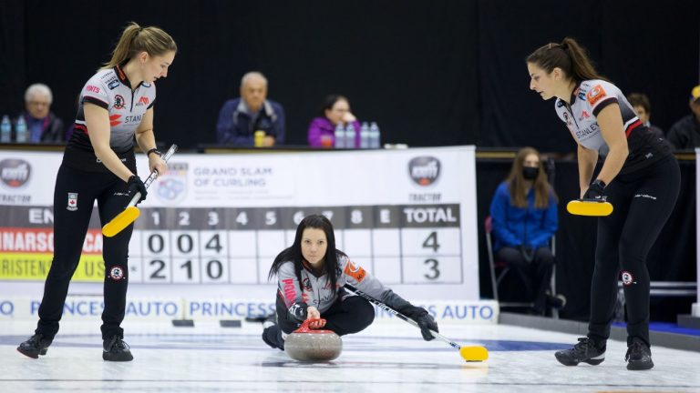 Kerri Einarson (centre) prepares to shoot a stone as Briane Meilleur (left) and Shannon Birchard (right) get ready to sweep during the second draw of the KIOTI Tractor Champions Cup on May 3, 2022, at the Olds Sportsplex in Olds, Alta. (Anil Mungal)
