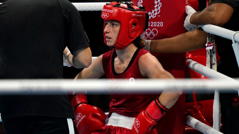 Canada's Mandy Bujold, centre, sits in her corner between rounds of a women's flyweight 51-kg boxing match against Serbia's Nina Radovanovic at the 2020 Summer Olympics, Saturday, July 24, 2021, in Tokyo, Japan. (Frank Franklin II/AP)