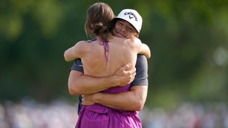 Sam Burns hugs his wife, Caroline Burns, after winning the Charles Schwab Challenge golf tournament at the Colonial Country Club in Fort Worth, Texas, Sunday, May 29, 2022. (LM Otero/AP)