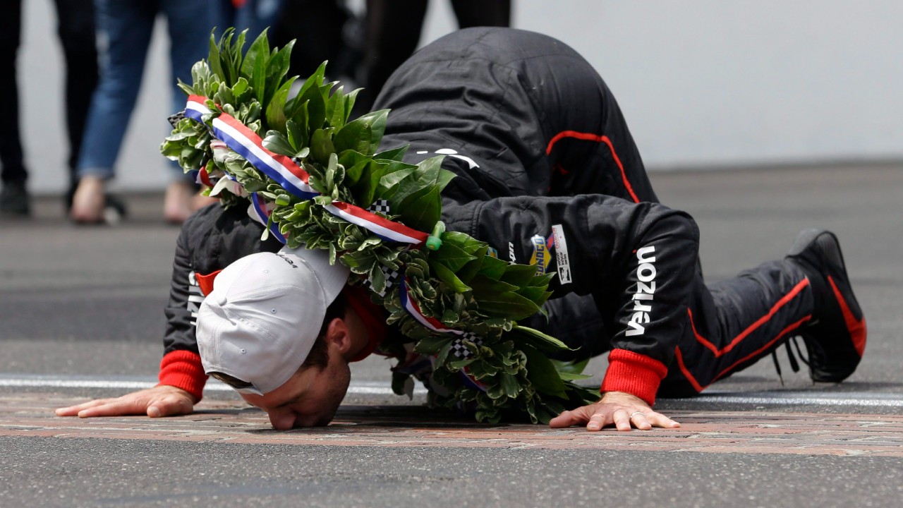 Will Power, of Australia, kisses the yard of bricks on the start/finish line as he celebrates winning the Indianapolis 500 auto race at Indianapolis Motor Speedway, in Indianapolis Sunday, May 27, 2018. (AJ Mast/AP)