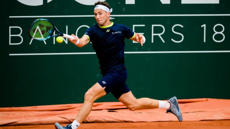 Casper Ruud of Norway returns a ball to Thanasi Kokkinakis of Australia during their quarter-final match, at the ATP 250 Geneva Open Tennis tournament in Geneva, Switzerland, Thursday, May 19, 2022. (Jean-Christophe Bott/Keystone via AP)