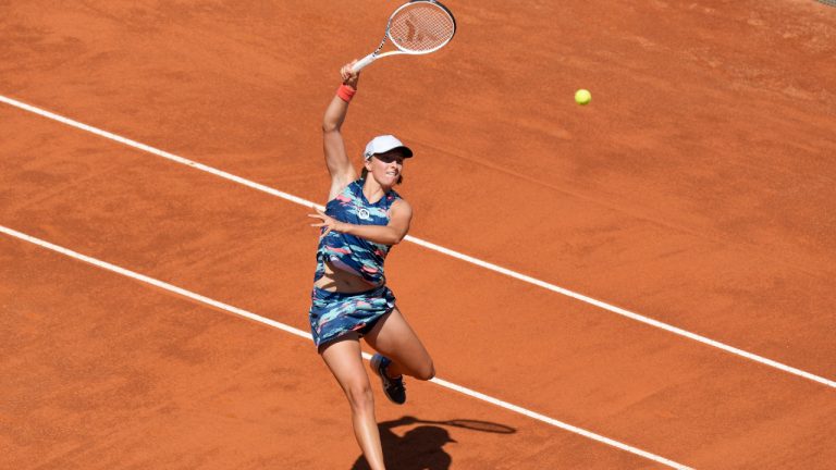 Iga Swiatek of Poland returns the ball to Victoria Azarenka of Belarus during their match at the Italian Open tennis tournament, in Rome, Thursday, May 12, 2022. (Andrew Medichini/AP)