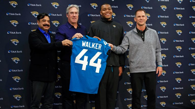 Jacksonville Jaguars owner Shad Khan, from left, head coach Doug Pederson, first round draft pick Travon Walker, and Jacksonville Jaguars General Manager Trent Baalke hold a jersey during a press conference Friday, April 29, 2022 at TIAA Bank Field in Jacksonville, Fla. (Corey Perrine/The Florida Times-Union via AP)