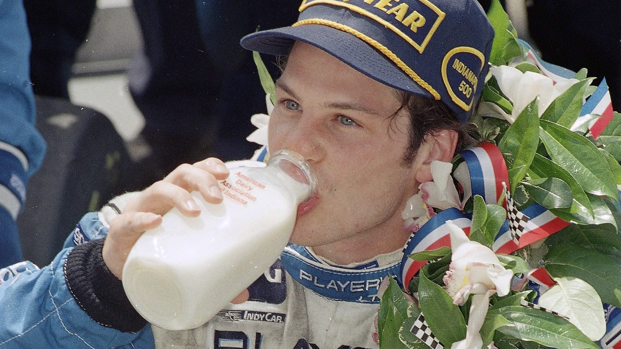 In this May 28, 1995 file photo, Jacques Villeneuve drinks milk in Victory Lane after winning the 79th running of the Indianapolis 500 auto race at Indianapolis Motor Speedway. (Al Behrman/AP)