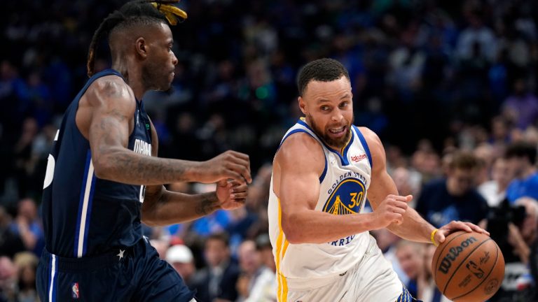 Golden State Warriors guard Stephen Curry (30) drives to the basket past Dallas Mavericks forward Reggie Bullock, left, during the second half of Game 3 of the NBA basketball playoffs Western Conference finals, Sunday, May 22, 2022, in Dallas. The Warriors won 109-100. (Tony Gutierrez/AP)