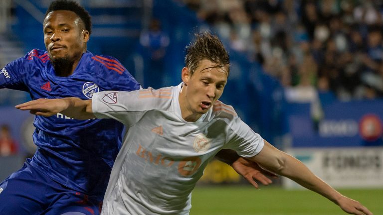 FC Cincinnati defender Alvas Powell, left, and CF Montreal midfielder Lassi Lappalainen battle during second half MLS action in Montreal on Saturday, May 28, 2022. CF Montréal is looking to keep its strong run of form going as it returns from Major League Soccer's two week international break with a match Saturday against Austin FC. (Peter McCabe/CP)