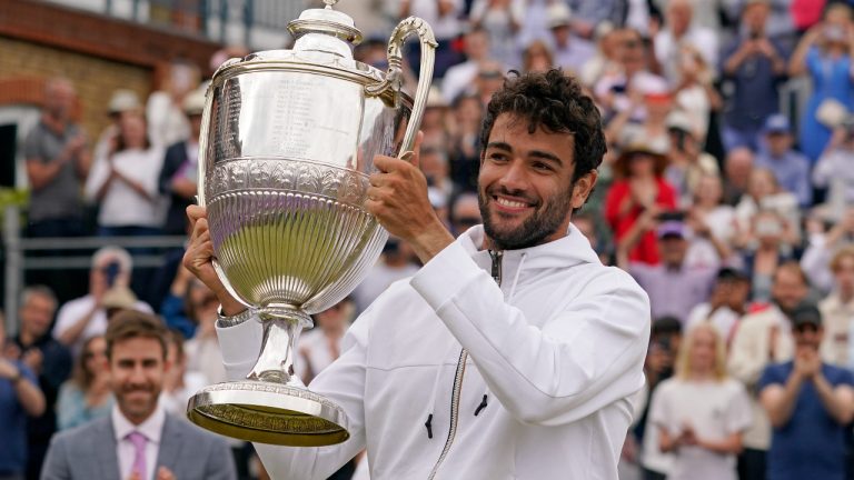 Italy's Matteo Berrettini celebrates with the trophy after beating Serbia's Filip Krajinovic to win the final tennis match at the Queen's Club Championships in London. (Alberto Pezzali/AP)