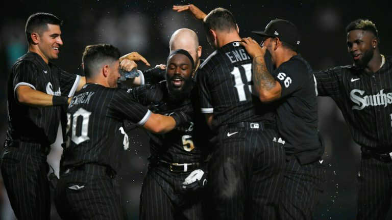 Chicago White Sox's Josh Harrison (5) celebrates with teammates after hitting a walk-off RBI single to defeat the Toronto Blue Jays 7-6 in twelve innings of a baseball game Tuesday, June 21, 2022, in Chicago. (AP Photo/Paul Beaty)