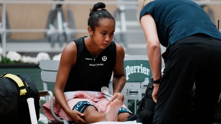 Canada's Leylah Fernandez receives medical assistance during her quarterfinal match against Italy's Martina Trevisan at the French Open. (Thibault Camus/AP)