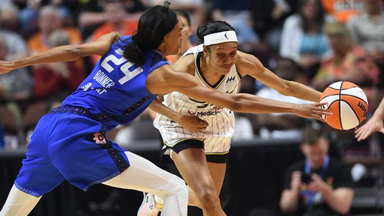 Connecticut Sun forward DeWanna Bonner (24) tries to slow Chicago Sky guard Rebekah Gardner during a WNBA basketball game Friday, June 10. 2022, in Uncasville, Conn. (Sean D. Elliot/The Day via AP)