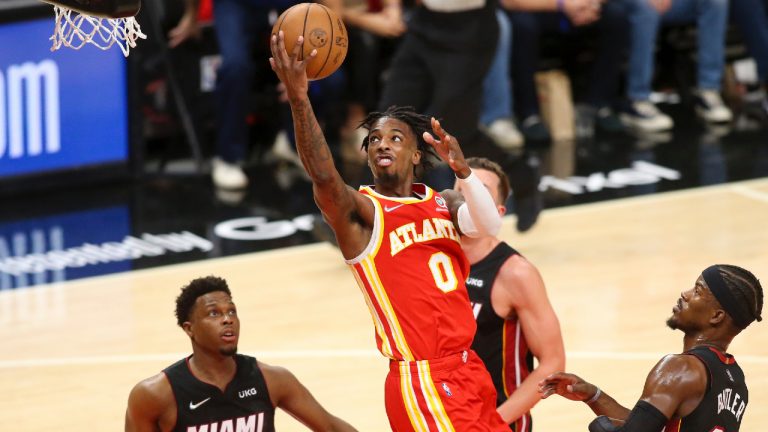 Atlanta Hawks guard Delon Wright shoots in front of Miami Heat defenders Kyle Lowry, left, and Jimmy Butler, right, during the first half of Game 3 of an NBA basketball first-round playoff series Friday, April 22, 2022, in Atlanta. (Brett Davis/AP)