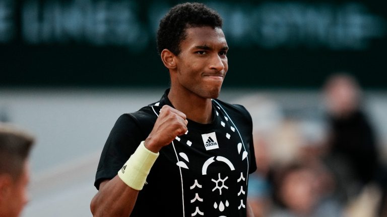 Canada's Felix Auger-Aliassime clenches his fist after scoring a point against Spain's Rafael Nadal during their fourth round match at the French Open tennis tournament in Roland Garros stadium in Paris, France, Sunday, May 29, 2022. (Thibault Camus/AP)