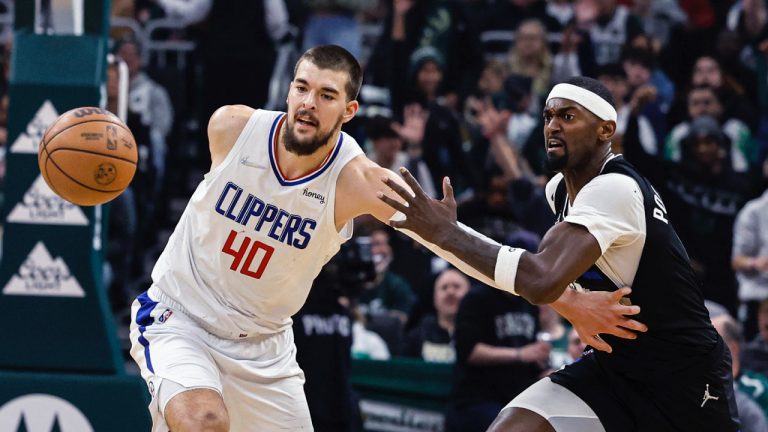 Los Angeles Clippers' Ivica Zubac(40) chases the ball next to Milwaukee Bucks' Bobby Porter during the first half of an NBA basketball game Friday, April 1, 2022, in Milwaukee. (Jeffrey Phelps/AP)