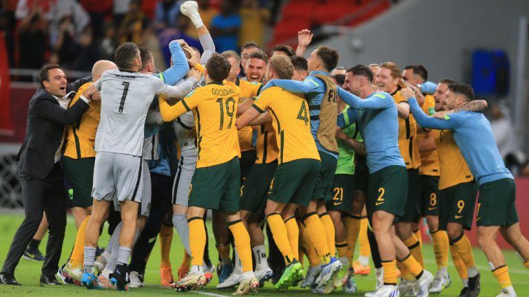Australian players celebrate after winning in a penalty shoot-out during the World Cup 2022 qualifying play-off soccer match between Australia and Peru in Al Rayyan, Qatar, Monday, June 13, 2022. (Hussein Sayed/AP)