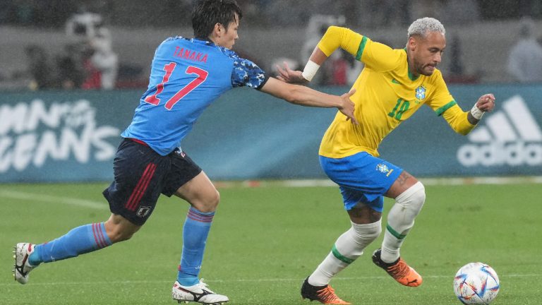 Neymar of Brazil, right, fights for the ball against Ao Tanaka of Japan during a friendly match at the National Stadium in Tokyo Monday, June 6, 2022. (Eugene Hoshiko/AP)