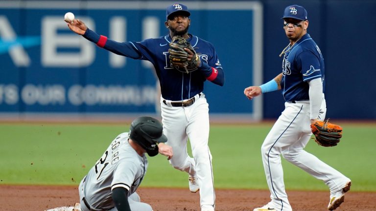 Tampa Bay Rays shortstop Vidal Brujan, centre, forces Chicago White Sox's Reese McGuire, left, at second base and relays the throw to first in time to turn a double play on Leury Garcia during the third inning of a baseball game Saturday, June 4, 2022, in St. Petersburg, Fla. Looking on is second baseman Isaac Paredes. (Chris O'Meara/AP)