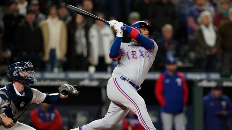 Texas Rangers' Willie Calhoun flies out for the final out in the team's baseball game against the Seattle Mariners, Tuesday, April 19, 2022, in Seattle. The Mariners won 6-2. (Ted S. Warren/AP)