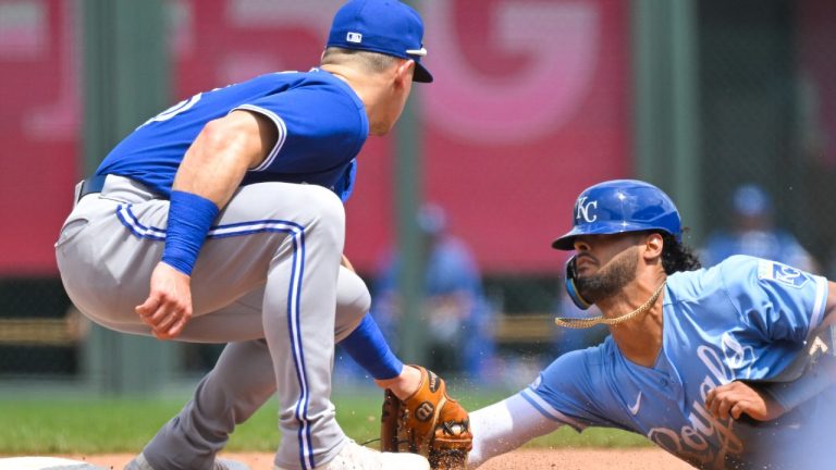 The Royals' Emmanuel Rivera, right, is caught stealing second base by Toronto Blue Jays third baseman Matt Chapman, left, during the fourth inning of a baseball game, Wednesday, June 8, 2022, in Kansas City, Mo. (Reed Hoffmann/AP)