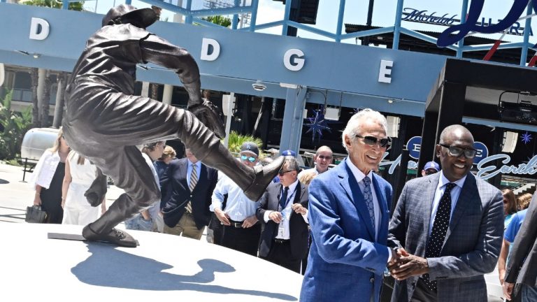 Sandy Koufax, left, shakes hands with the sculptor of his statue, Brandly Cadet, as the Los Angeles Dodgers unveil the statue in the Centerfield Plaza to honor the Hall of Famer and three-time Cy Young Award winner prior to a baseball game between the Cleveland Guardians and the Dodgers at Dodger Stadium in Los Angeles, Saturday, June 18, 2022. (Keith Birmingham/The Orange County Register via AP)