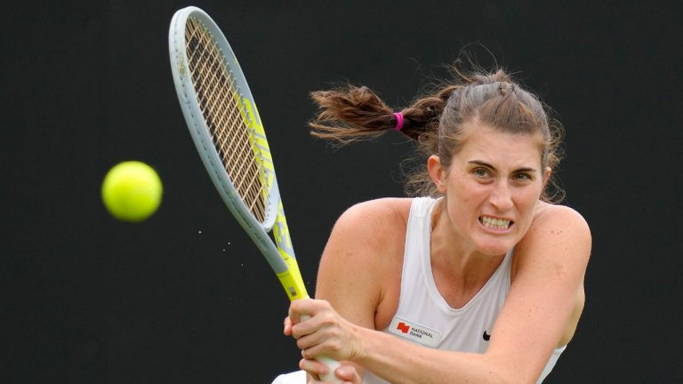 Rebecca Marino of Canada plays a return to Camila Giorgi of Italy during their singles tennis match at the Eastbourne International tennis tournament in Eastbourne, England, Tuesday, June 21, 2022. (Kirsty Wigglesworth/AP)