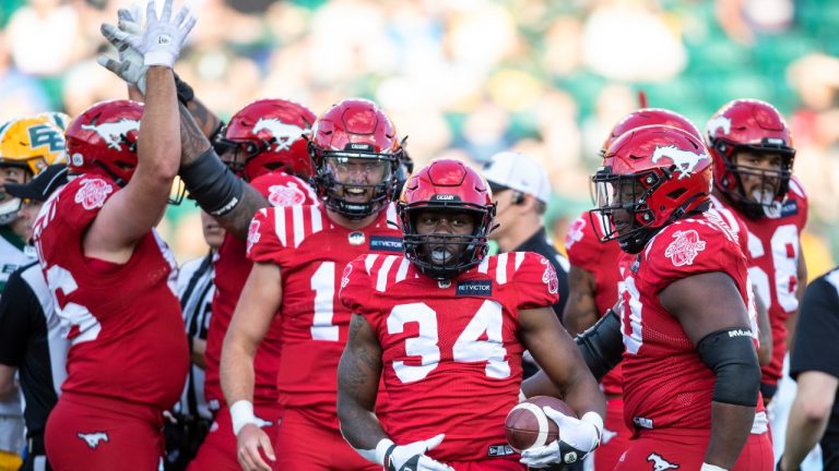 Calgary Stampeders Dedrick Mills (34) celebrate a touchdown with teammates against the Edmonton Elks during first half CFL pre season action in Edmonton, Friday, June 3, 2022. (Jason Franson/CP)