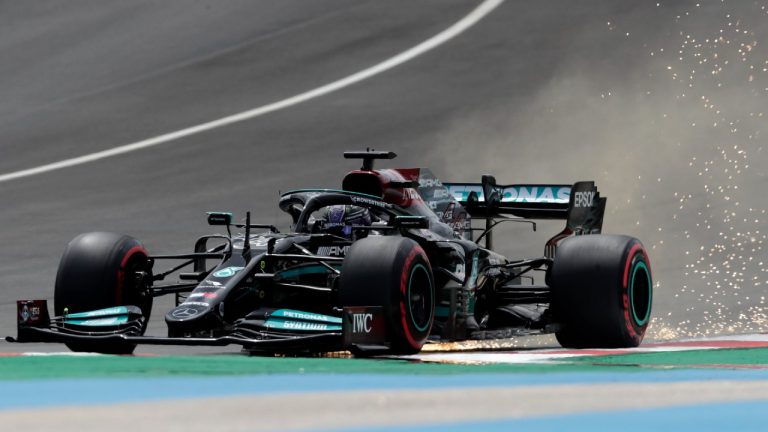 The car of Mercedes driver Lewis Hamilton of Britain leaves a trail of sparks as it bounces along the course at the Portugal Grand Prix in early May. (Manu Fernandez/AP)
