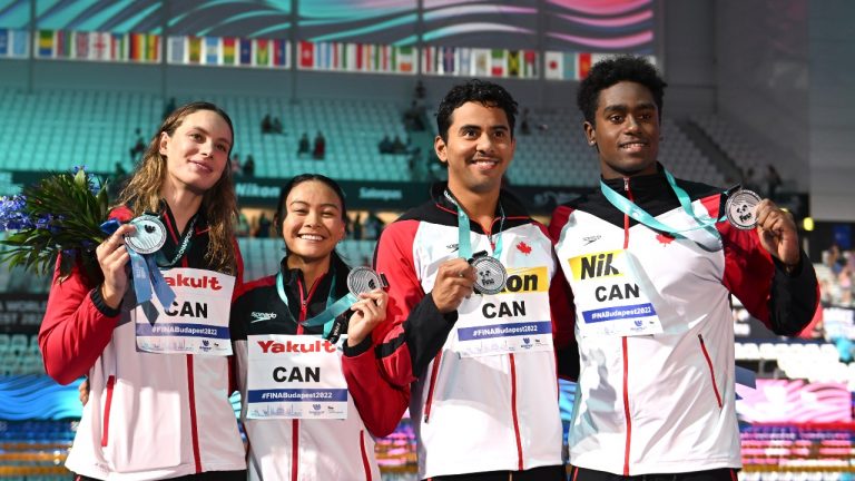 From left to right, Penny Oleksiak, Kayla Sanchez, Javier Acevedo and Joshua Liendo celebrate after winning silver in the mixed relay at the World Championships on June 24. (AP Photo)