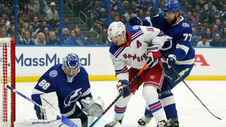 New York Rangers centre Ryan Strome (16) tries to stuff the puck under Tampa Bay Lightning goaltender Andrei Vasilevskiy (88) as defenseman Victor Hedman (77) looks on during the first period in Game 3 of the NHL hockey Stanley Cup playoffs Eastern Conference finals. (Chris O'Meara/AP)