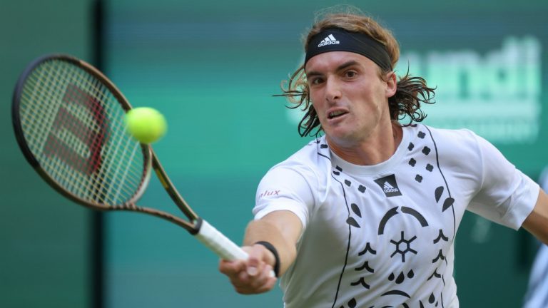 Stefanos Tsitsipas of Greece returns to France's Benjamin Bonzi during their match at the ATP tennis tournament in Halle, Germany, Tuesday, June 14, 2022. (Friso Gentsch/dpa via AP)
