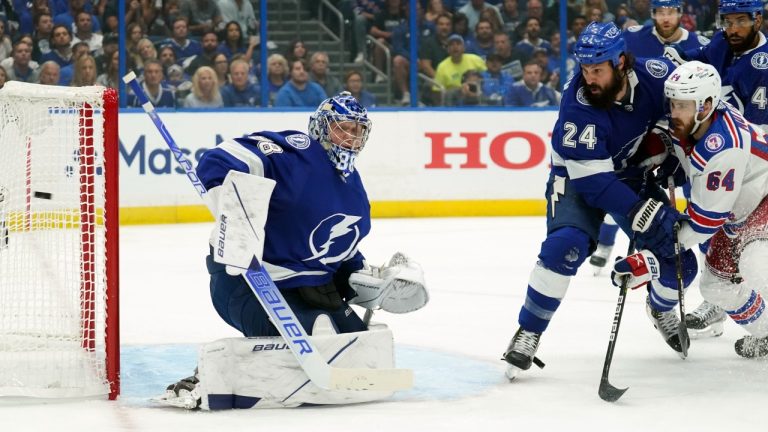 Tampa Bay Lightning goaltender Andrei Vasilevskiy (88) makes a blocker save as defenceman Zach Bogosian (24) keeps New York Rangers centre Tyler Motte (64) from a rebound during the first period in Game 3 of the NHL hockey Stanley Cup playoffs Eastern Conference final Sunday, June 5, 2022, in Tampa, Fla. (Chris O'Meara/AP)