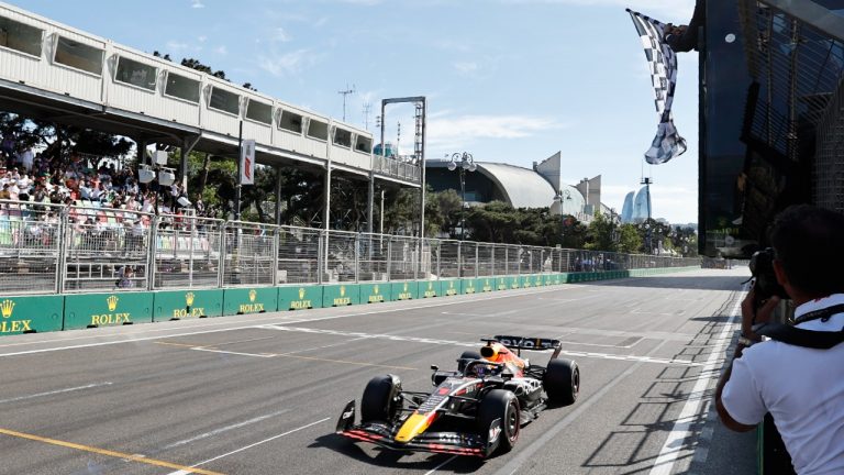 Red Bull driver Max Verstappen of the Netherlands crosses the finish line to win the Azerbaijan Formula One Grand Prix at the Baku circuit, in Baku, Azerbaijan, Sunday, June 12, 2022. (Hamad Mohammed, Pool Via AP)