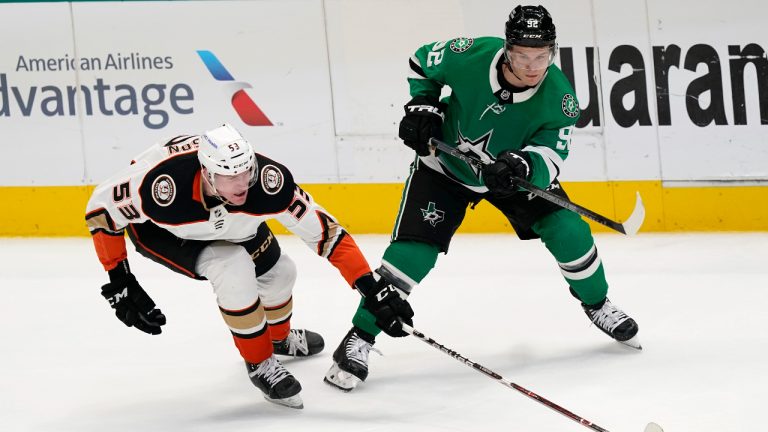Anaheim Ducks right wing Buddy Robinson (53) and Dallas Stars center Vladislav Namestnikov (92) vie for control of the puck during the first period of an NHL hockey game in Dallas, Friday, April 29, 2022. (AP Photo/LM Otero)