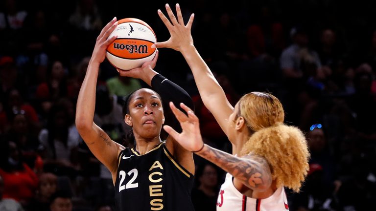Las Vegas Aces forward A'ja Wilson (22) is guarded by Washington Mystics center Shakira Austin (0) during the first half of a WNBA basketball game Saturday, June 25, 2022, in Las Vegas. (Steve Marcus/Las Vegas Sun via AP)