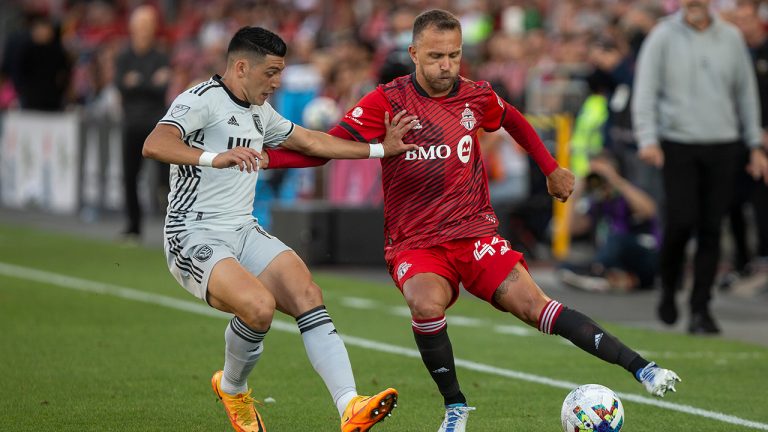 Toronto FC's new signing Domenico Criscito (right) cuts inside of San Jose Earthquakes forward Cristian Espinoza (10) during first half MLS action in Toronto on Saturday July 9, 2022. (Chris Young/CP)