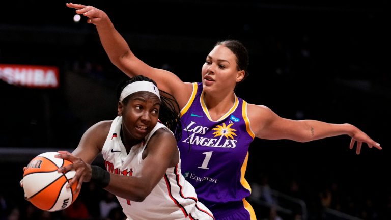 Washington Mystics center Elizabeth Williams, left, gets a rebound next to Los Angeles Sparks center Liz Cambage during the first half of a WNBA basketball game Tuesday, July 12, 2022, in Los Angeles. (Keith Birmingham/The Orange County Register via AP)