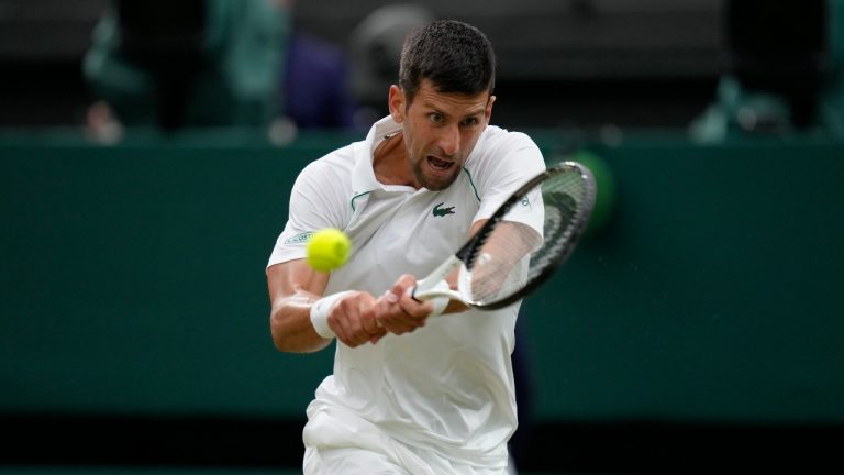 Serbia's Novak Djokovic returns the ball to Tim van Rijthoven of the Netherlands during a men's fourth round singles match on day seven of the Wimbledon tennis championships in London, Sunday, July 3, 2022.(Kirsty Wigglesworth/AP Photo)