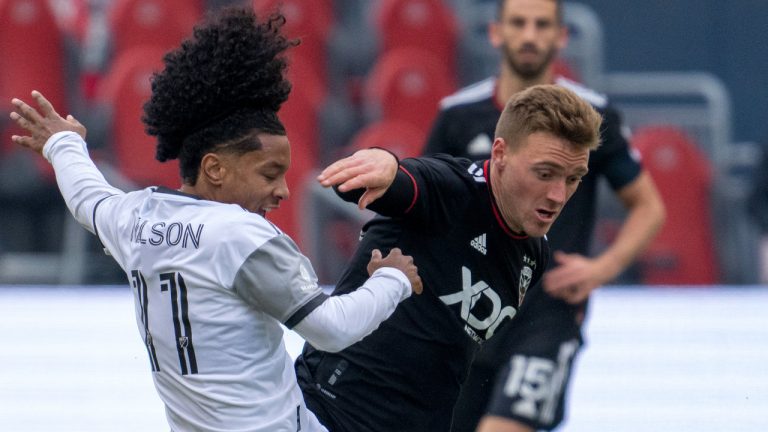 D.C. United defender Julian Gressel (31) fouls Toronto FC forward Jayden Nelson (11) during first half MLS in Toronto on Saturday March 19, 2022. (Frank Gunn/CP)