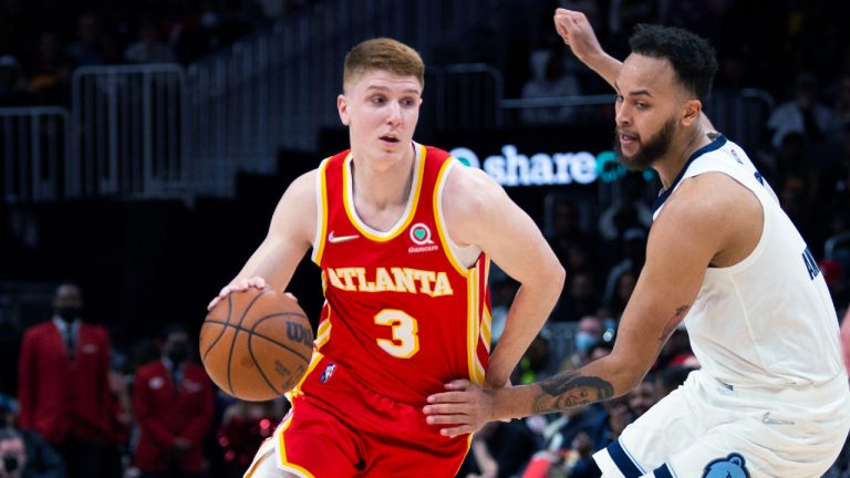 Atlanta Hawks guard Kevin Huerter (3) dribbles past Memphis Grizzlies forward Kyle Anderson (1) during the second half of an NBA basketball game Friday, March 18, 2022, in Atlanta. (Hakim Wright Sr./AP)