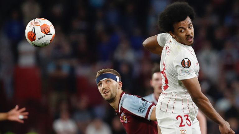 Sevilla's Jules Kounde, right, jumps for the ball by West Ham's Pablo Fornals during the Europa League round of 16 first leg soccer match between Sevilla and West Ham at the Ramon Sanchez-Pizjuan stadium, in Seville, Spain, Thursday, March 10, 2022. (Angel Fernandez/AP)