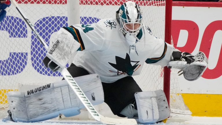 San Jose Sharks goaltender Kaapo Kahkonen makes a stick-save of a shot against the Colorado Avalanche in the second period of an NHL hockey game Thursday, March 31, 2022, in Denver. (David Zalubowski/AP)
