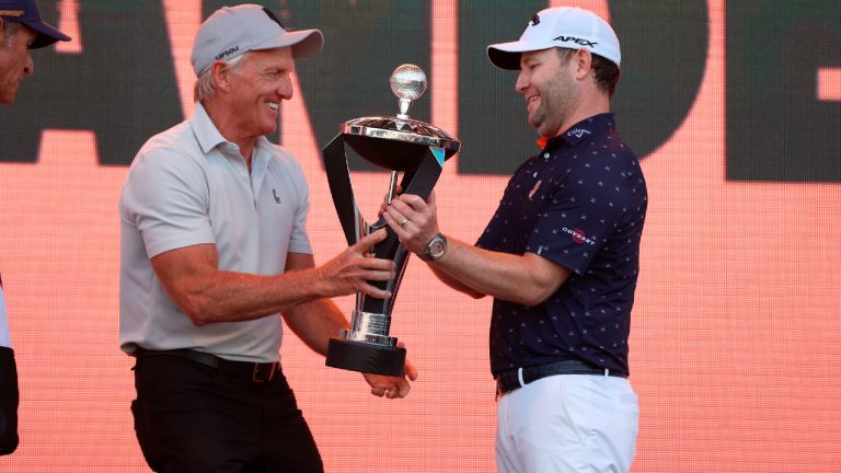 LIV Golf CEO Greg Norman, left, hands the trophy to Branden Grace, right, at the Portland Invitational LIV Golf tournament in North Plains, Ore., Saturday, July 2, 2022. (Steve Dipaola/AP)