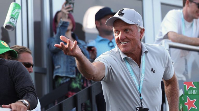 Greg Norman, CEO of LIV Golf, tosses a beer to spectators into the crowd surrounding the 18th green at the Portland Invitational LIV Golf tournament in North Plains, Ore., Saturday, July 2, 2022. (Steve Dipaola/AP)