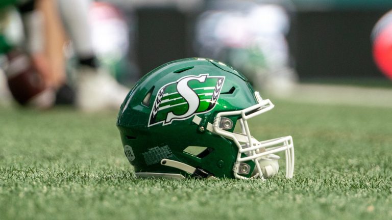 A football helmet sits on the field before CFL football action with the Hamilton Tiger-Cats playing the Saskatchewan Roughriders in Regina on Saturday, June 11, 2022. (Heywood Yu/THE CANADIAN PRESS)