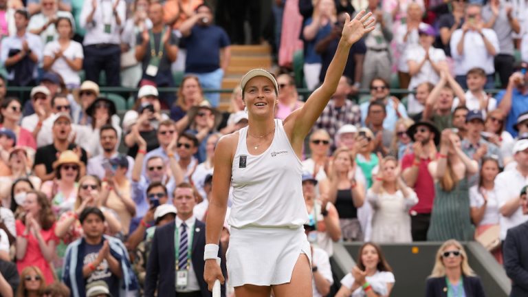 Germany's Tatjana Maria celebrates defeating Latvia's Jelena Ostapenko during a fourth round women's singles match on day seven of the Wimbledon tennis championships in London, Sunday, July 3, 2022. (Alberto Pezzali/AP)