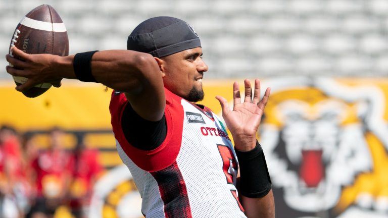 Ottawa Redblacks quarterback Caleb Evans (5) throws prior to CFL football game action against the Hamilton Tiger Cats in Hamilton, Ont., Saturday, July 16,2022. (Peter Power/CP)