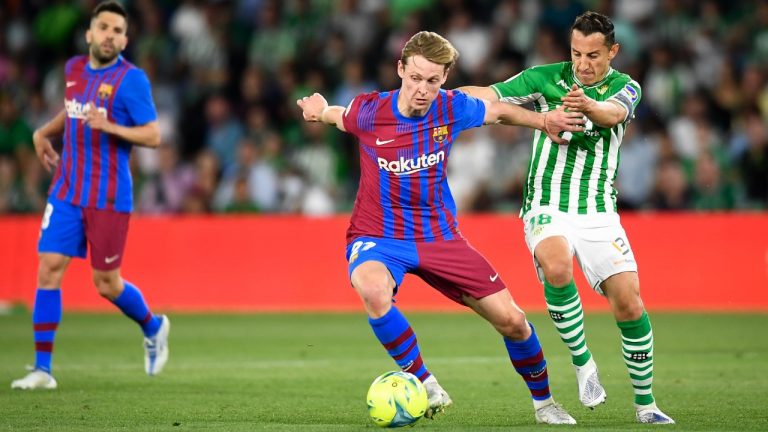 Betis' Andres Guardado, right, challenges for the ball with Barcelona's Frenkie de Jong during the Spanish La Liga soccer match between Real Betis and Barcelona at Benito Villamarin stadium in Seville, Spain, Saturday, May 7, 2022. (Jose Breton/AP)