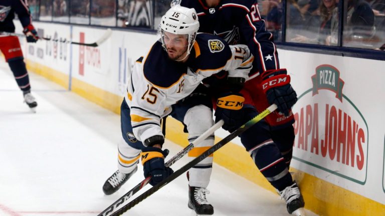 Buffalo Sabres forward Jean-Sebastien Dea, front, reaches for the puck next to Columbus Blue Jackets forward Riley Nash during the second period of an NHL preseason hockey game in Columbus, Ohio, Tuesday, Sept. 17, 2019. (Paul Vernon/AP)